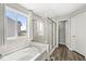 Bright bathroom with a soaking tub, glass shower, and wood-look flooring at 4763 Denton Dr, Zionsville, IN 46077
