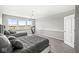 Bright bedroom featuring two beds, a chandelier, neutral colors, and large windows overlooking the outside at 4763 Denton Dr, Zionsville, IN 46077