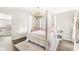 Bright bedroom features a canopy bed, side table, and a cozy armchair at 4763 Denton Dr, Zionsville, IN 46077