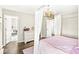 Cozy bedroom with a canopy bed, dresser, and an adjacent room visible in the doorway at 4763 Denton Dr, Zionsville, IN 46077