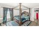 Elegant bedroom featuring a four-poster bed, patterned rug, and bright natural light at 4763 Denton Dr, Zionsville, IN 46077