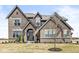 Beautiful two-story brick home showcasing a landscaped front yard and elegant architectural details at 4763 Denton Dr, Zionsville, IN 46077