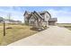Elegant two-story brick home with a well-manicured lawn and a paved driveway leading to the garage at 4763 Denton Dr, Zionsville, IN 46077