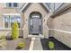 Close-up of a home's entryway, featuring a stylish gray front door with sidelights and meticulous landscaping at 4763 Denton Dr, Zionsville, IN 46077