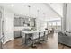 Bright, open-concept kitchen featuring a large island with seating, modern appliances, and hardwood floors at 4763 Denton Dr, Zionsville, IN 46077