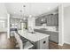 Modern kitchen with gray cabinets, stainless steel appliances, and a large island with white countertop and seating at 4763 Denton Dr, Zionsville, IN 46077