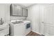 Clean laundry room with washer, dryer, utility sink, and ample cabinet space at 4763 Denton Dr, Zionsville, IN 46077