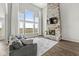 Bright living room features a stone fireplace, large windows, wood floors, and comfortable gray seating at 4763 Denton Dr, Zionsville, IN 46077