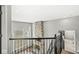 Second floor view of living room with stone fireplace and large windows at 4763 Denton Dr, Zionsville, IN 46077