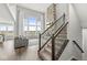 Bright living room with tall windows, stone fireplace, and elegant staircase at 4763 Denton Dr, Zionsville, IN 46077