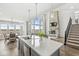 Expansive living space with kitchen island, dining area, living room with fireplace, and staircase at 4763 Denton Dr, Zionsville, IN 46077