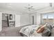 Bright main bedroom with carpet, tray ceiling, and access to the staircase at 4763 Denton Dr, Zionsville, IN 46077