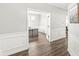 Bright home office featuring a modern desk, hardwood floors, white wainscoting, and large windows at 4763 Denton Dr, Zionsville, IN 46077