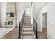 Staircase with metal railing leading to upper level with living room fireplace view at 4763 Denton Dr, Zionsville, IN 46077
