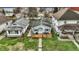 Aerial view of home featuring a cozy front porch, lush lawn, and close proximity to neighboring houses at 4933 Ford St, Indianapolis, IN 46224