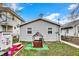 A backyard featuring a playhouse, a play table and charming landscaping at 4933 Ford St, Indianapolis, IN 46224