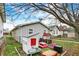 A backyard featuring a playhouse, a play table and charming landscaping at 4933 Ford St, Indianapolis, IN 46224