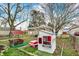 A backyard featuring a playhouse, a play table and charming landscaping at 4933 Ford St, Indianapolis, IN 46224