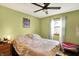 Bedroom with a ceiling fan, large window, and comfortable furnishings at 4933 Ford St, Indianapolis, IN 46224