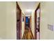 Hallway featuring wood flooring and doors leading to various rooms throughout the home at 4933 Ford St, Indianapolis, IN 46224