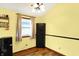 Kitchen with black compact fridge, a window and wood-look vinyl floors at 4933 Ford St, Indianapolis, IN 46224