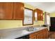View of the kitchen with stainless steel sink, light counter tops and wood cabinets at 4933 Ford St, Indianapolis, IN 46224