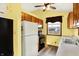 Bright kitchen featuring white appliances, oak cabinets and wood-look vinyl floors at 4933 Ford St, Indianapolis, IN 46224