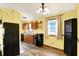 Charming kitchen features wood cabinets and black appliances, brightened by a window at 4933 Ford St, Indianapolis, IN 46224