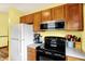 Kitchen area featuring essential appliances, wood cabinets and light counter tops at 4933 Ford St, Indianapolis, IN 46224