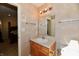 Compact bathroom featuring a vanity sink, mirror, lighting fixtures, and neutral colored wall at 4951 Tuscany Ln, Indianapolis, IN 46254