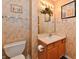 Cozy bathroom featuring a framed mirror, vanity with storage, and decorative wallpaper at 4951 Tuscany Ln, Indianapolis, IN 46254