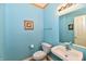 Charming powder room with bright blue walls, white fixtures, and a decorative mirror at 4951 Tuscany Ln, Indianapolis, IN 46254
