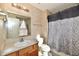 Bright bathroom showcasing a vanity sink, a toilet, and a shower with a patterned curtain at 4951 Tuscany Ln, Indianapolis, IN 46254