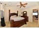 Bedroom with dark wood furniture, ceiling fan, and neutral walls at 4951 Tuscany Ln, Indianapolis, IN 46254