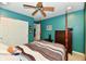 Bedroom with painted walls, four-poster bed, ceiling fan, closet, and adjacent room access at 4951 Tuscany Ln, Indianapolis, IN 46254
