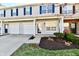 Charming townhome features an attached garage, a well-manicured lawn, and tidy landscaping at 4951 Tuscany Ln, Indianapolis, IN 46254