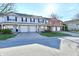 Inviting townhomes feature attached garages, lush landscaping, and charming curb appeal on a sunny day at 4951 Tuscany Ln, Indianapolis, IN 46254