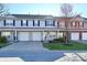 Attractive townhome featuring an attached garage, a well-manicured lawn, and tidy landscaping at 4951 Tuscany Ln, Indianapolis, IN 46254