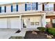 Lovely townhome featuring an attached garage, a well-manicured lawn, and tidy landscaping at 4951 Tuscany Ln, Indianapolis, IN 46254