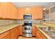 This kitchen is equipped with stainless steel appliances and wood cabinets at 4951 Tuscany Ln, Indianapolis, IN 46254