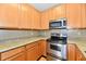 This kitchen is equipped with stainless steel appliances and wood cabinets at 4951 Tuscany Ln, Indianapolis, IN 46254