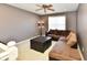 Cozy living room with a brown sectional sofa, ceiling fan, and neutral walls at 4951 Tuscany Ln, Indianapolis, IN 46254