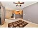 Open concept living and kitchen space with a ceiling fan and half-wall at 4951 Tuscany Ln, Indianapolis, IN 46254