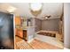 Open concept living room and kitchen with warm lighting, ceiling fan, and a decorative rug at 4951 Tuscany Ln, Indianapolis, IN 46254