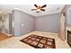 A cozy living room with neutral walls, white trim, ceiling fan and a brown geometric rug at 4951 Tuscany Ln, Indianapolis, IN 46254