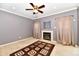Cozy living room with neutral walls, fireplace, ceiling fan, and warm, neutral curtains at 4951 Tuscany Ln, Indianapolis, IN 46254