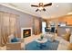 Staged living room featuring a fireplace, neutral walls, kitchen access, and an accent rug at 4951 Tuscany Ln, Indianapolis, IN 46254