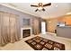 Open concept living room with a fireplace, neutral walls, kitchen access, and wood floors at 4951 Tuscany Ln, Indianapolis, IN 46254