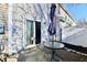 Back patio featuring a glass table, closed umbrella, sliding glass door, and vinyl fencing at 4951 Tuscany Ln, Indianapolis, IN 46254
