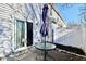Back patio area featuring a glass table, closed umbrella, siding, and a fence at 4951 Tuscany Ln, Indianapolis, IN 46254